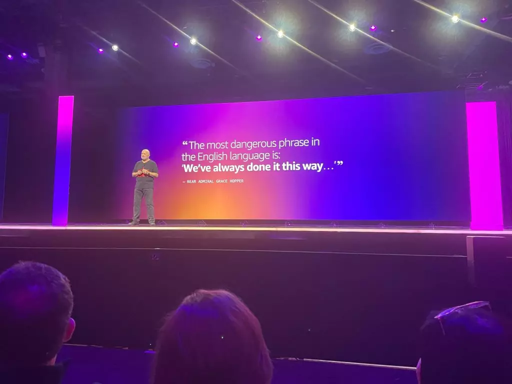Dr Wenrer's on stage at his AWS re:Invent keynote with a quotation on the screen 